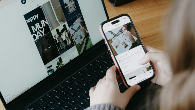 Wuger Mitarbeiter vergleicht für Digital Marketing Social Media Content auf Smartphone und Laptop