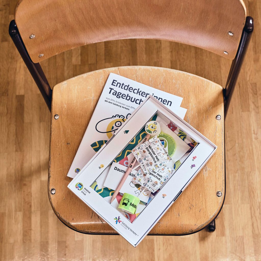 Die Entdeckerbox bündelt Lernmaterialien in einer vertrauten Schulumgebung und macht Mobilität ganzheitlich erlebbar. Foto zeigt eine Entdeckerbox auf einem Schulsessel, die Wuger für Event Marketing und Mobilitätserziehung entwickelt hat
